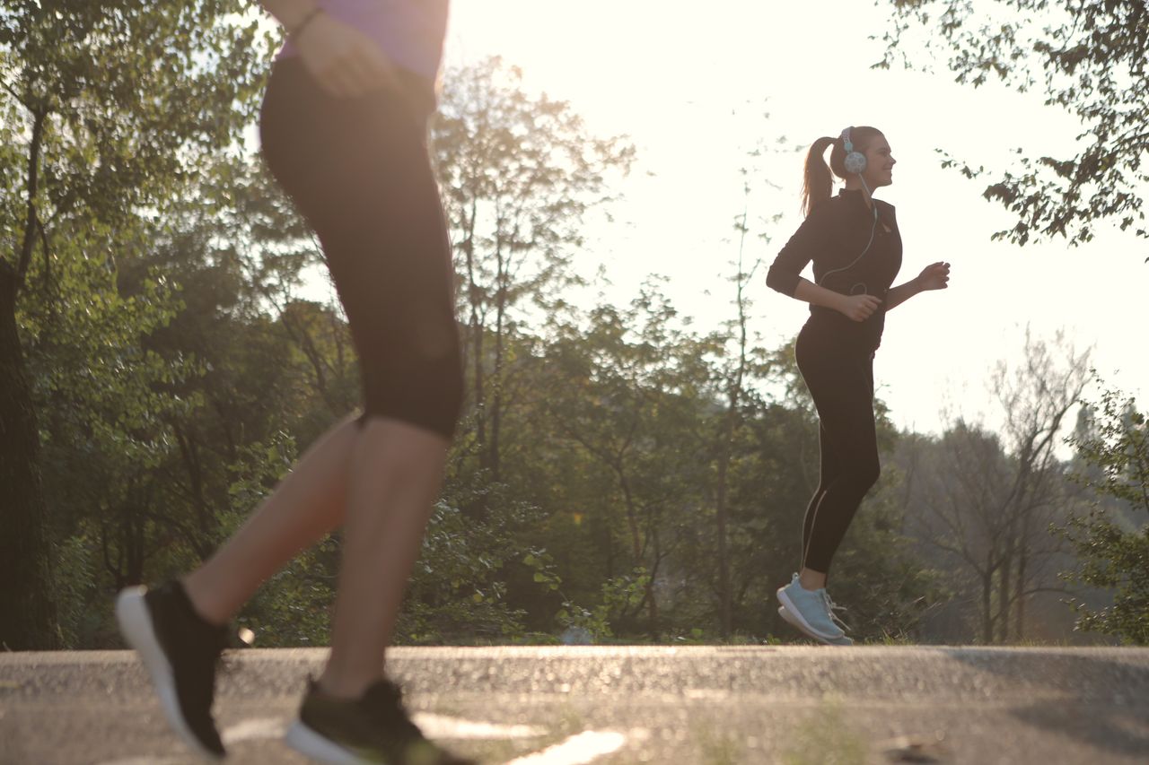 Mastering the First Impression: Your intriguing post title goes here Two women jogging in a sunny park setting, enjoying a healthy morning exercise.